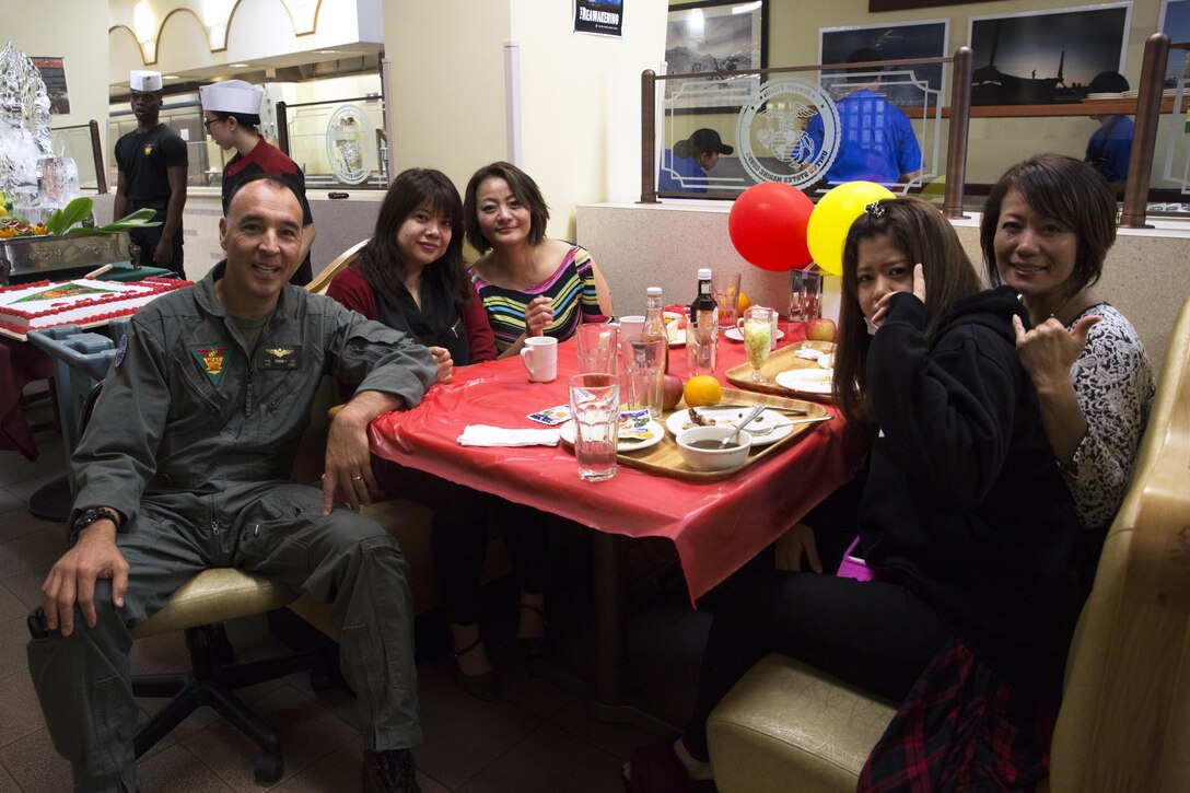 Col. Peter Lee poses for a photo with master labor contractors during the 241st Marine Corps Birthday celebration at the mess hall Nov. 9 on Marine Corps Air Station Futenma, Okinawa, Japan. The celebration was one of many held on installations across Okinawa to uphold the tradition of celebrating the Marine Corps’ birthday, which dates back to Nov. 10, 1775. The event featured a mouthwatering steak and lobster meal, a uniform pageant by Kubasaki High School Junior Reserve Officer Training Corps, and a live performance by the III Marine Expeditionary Force Band and was open to service members, civilian contractors, master labor contractors, and their families to celebrate together. Lee is the commanding officer of Marine Corps Air Station Futenma. (U.S. Marine Corps photo by Cpl. Janessa K. Pon/Released)