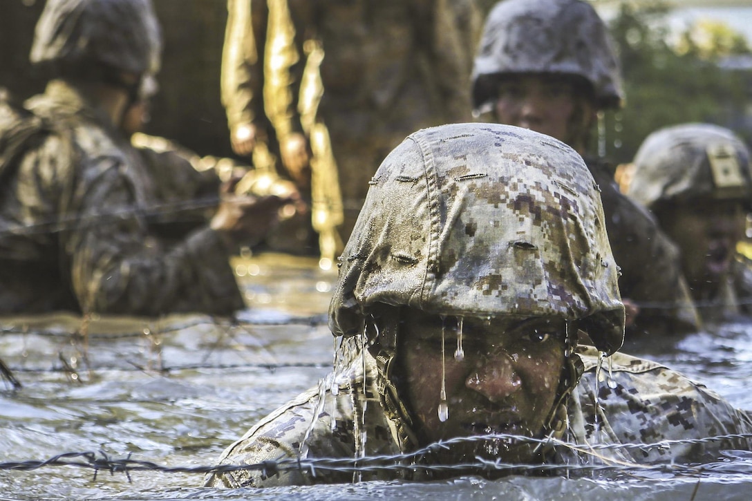 Marines and sailors crawl through a water obstacle during a squad competition at Marine Corps Base Camp Lejeune, N.C., Nov. 16, 2016. Marine Corps photo by Lance Cpl. Jack A.E. Rigsby