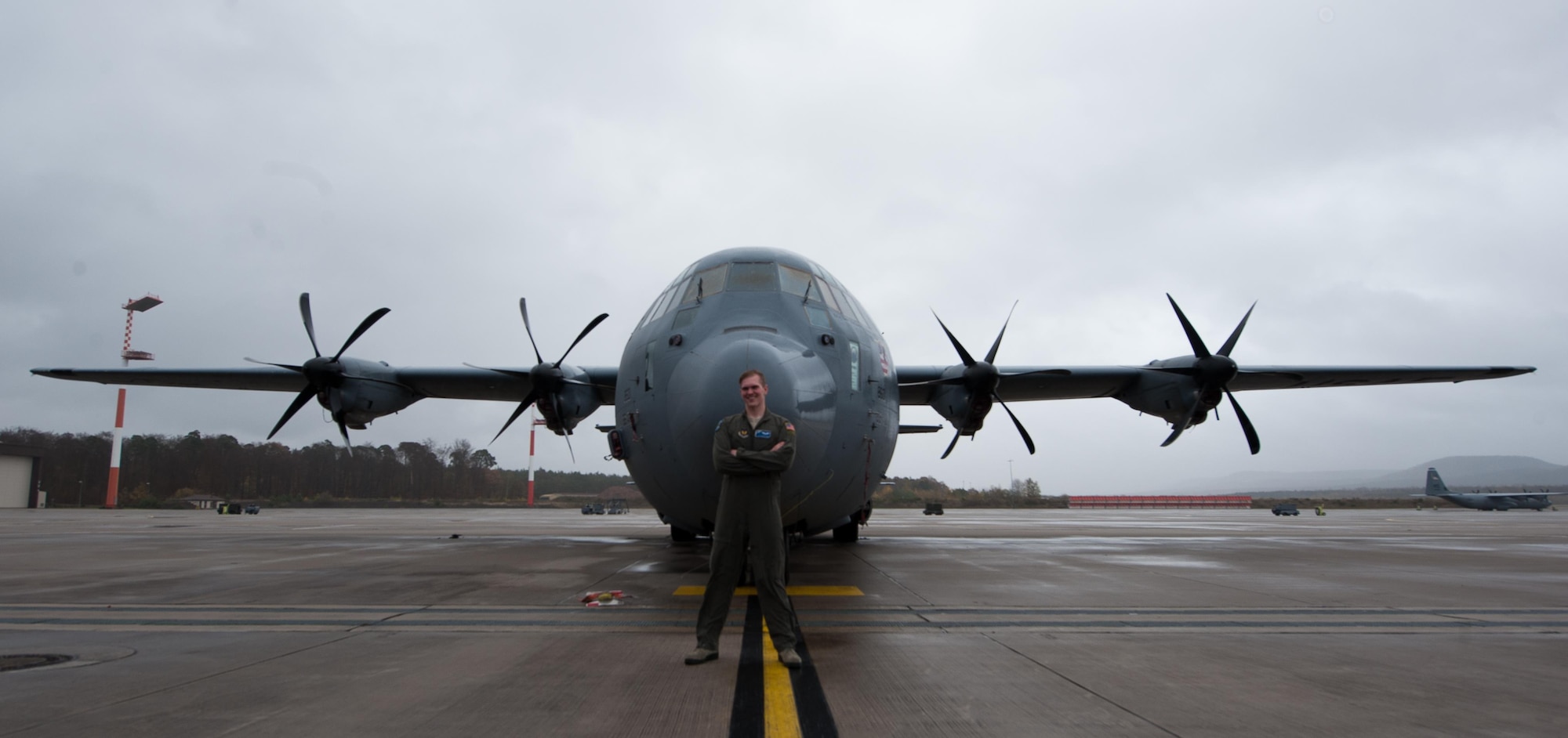 Airman 1st Class Patrick Stone, 37th Airlift Squadron loadmaster, poses in front of a C-130J Super Hercules at Ramstein Air Base, Germany, Nov. 17, 2016. Stone, along with wingman Staff Sgt. James Gaston, 37th AS loadmaster, worked together on creating a new repair program within their unit, which salvages usable parts from non-functional headsets to create complete units. In the first iteration of their program, Gaston and Stone were able to assemble nine fully-functional headsets from individual components, thus reducing the number of new headsets needing to be purchased. Together, they saved the Air Force $8,100. (U.S. Air Force photo by Airman 1st Class Lane T. Plummer)
