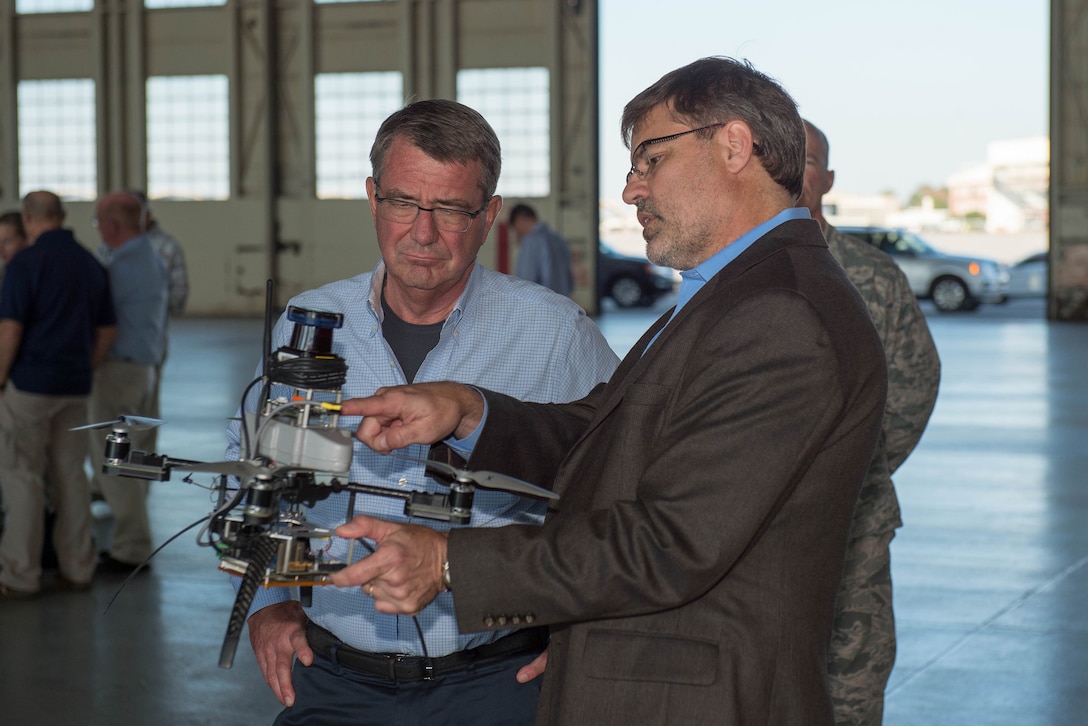Defense Secretary Ash Carter observes static displays of advanced weapons and unmanned aerial systems.