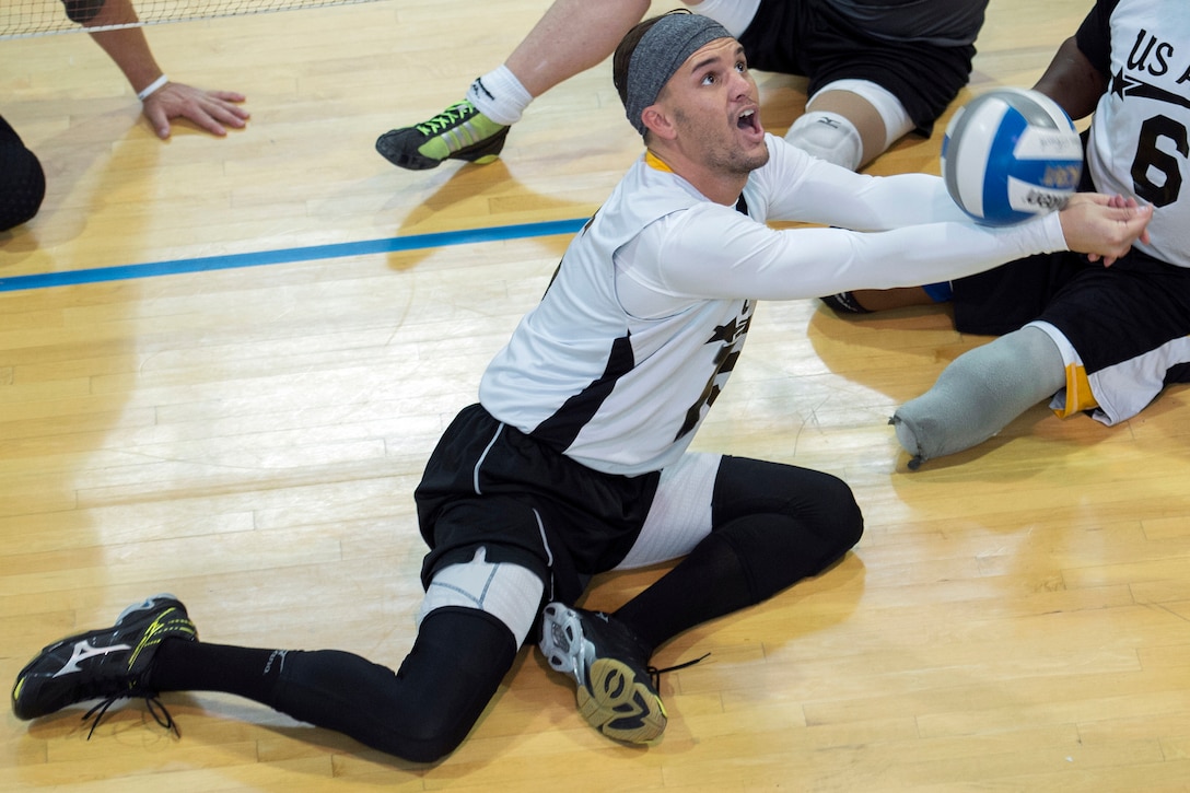 Army Sgt. Nicholas Titman sets a ball during the 2016 Warrior Care Month Joint Service Sitting Volleyball Tournament at the Pentagon in Arlington, Va., Nov. 19, 2016. DoD photo by EJ Hersom