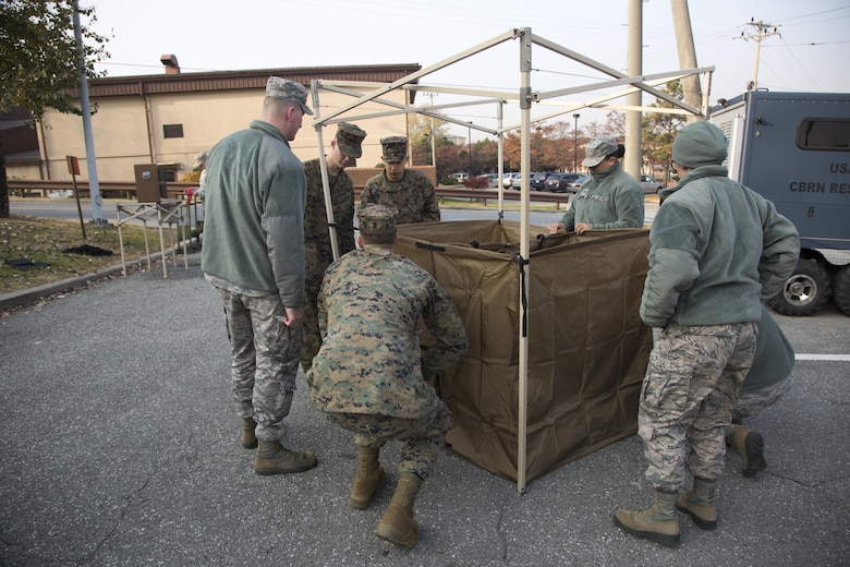 U.S. Marines and U.S. Airmen work together during a simulated contamination control area in preparation of Vigilant Ace 17-1 at Osan Air Base, Korea, Nov. 17, 2016. Vigilant Ace is a biannual, bilateral training event that exercises U.S. military and Republic of Korea Air Force interoperability through simulated wartime tasking. 