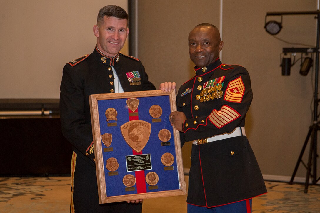 Colonel Jeffrey C. Smitherman, commanding officer of the 6th Marine Corps District, poses with Sgt. Maj. Samuel Heyward Jr., sergeant major of Marine Corps Recruiting Command, as he receives the gift provided by the Marines of the 6th MCD Nov. 10, 2016 at the Westin Hilton Head Island Resort and Spa in Hilton Head, South Carolina. Sergeant Major Heyward was the guest of honor at the district headquarters birthday ball. (Photo by Cpl. John-Paul Imbody/Released)