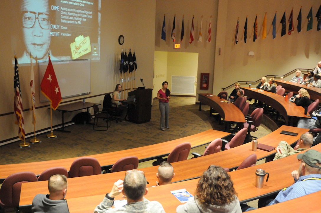 FORT MCCOY, Wisconsin (November 17, 2016) – Bella Hernandez, center, a special agent with the 752nd Military Intelligence Battalion, speaks to a crowd of Soldiers and civilians from the 88th Regional Support Command and Fort McCoy during the Threat Awareness and Reporting Program (TARP) training at the Blue Devil Auditorium in the 88th RSC headquarters, November 17.