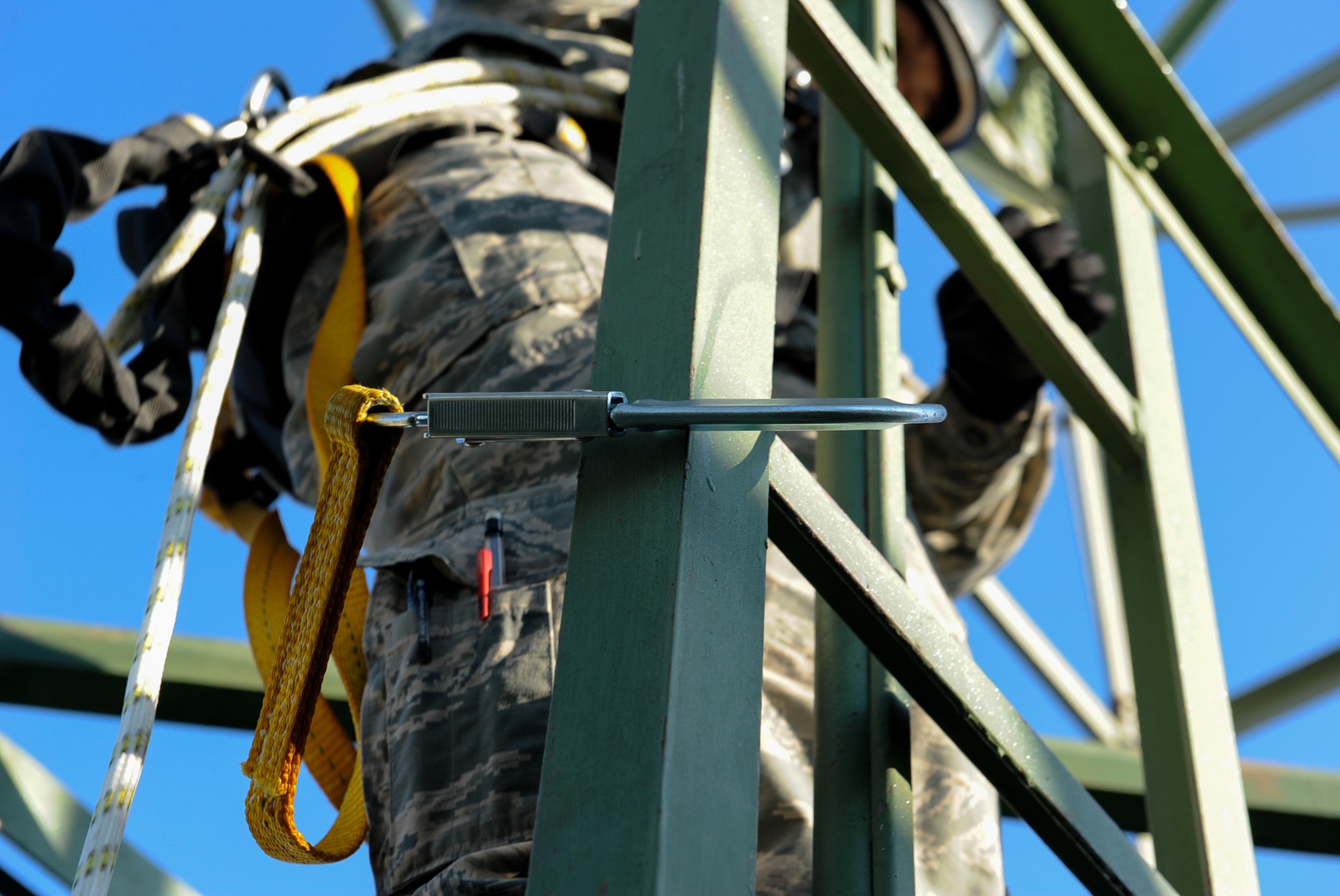 Senior Airman Nikki Erling, 86th Operations Support Squadron airfield systems technician, climbs down from an air traffic control radio antenna at Ramstein Air Base, Germany, Nov. 14, 2016. Airmen who climb the antennas go through a climbing certification course that includes a basic fear of heights test. (U.S. Air Force photo by Airman 1st Class Savannah L. Waters)