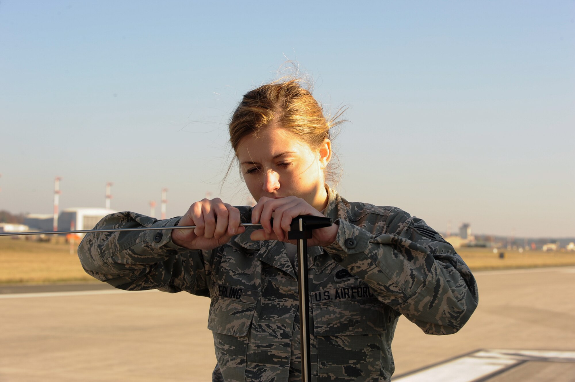 Senior Airman Nikki Erling, 86th Operations Support Squadron airfield systems technician, puts together an antenna at Ramstein Air Base, Germany, Nov. 14, 2016. The antenna is part of a specially built test vehicle the Air Traffic Control and Landing Systems flight uses to drive the length of the runway eight times with a larger antenna attached to the vehicle 12 meters in height to simulate an aircraft and ensure the signals are being brought directly down the centerline. This system is a zero visibility-auto land system that requires additional checks to verify the system is performing as required. (U.S. Air Force photo by Airman 1st Class Savannah L. Waters)