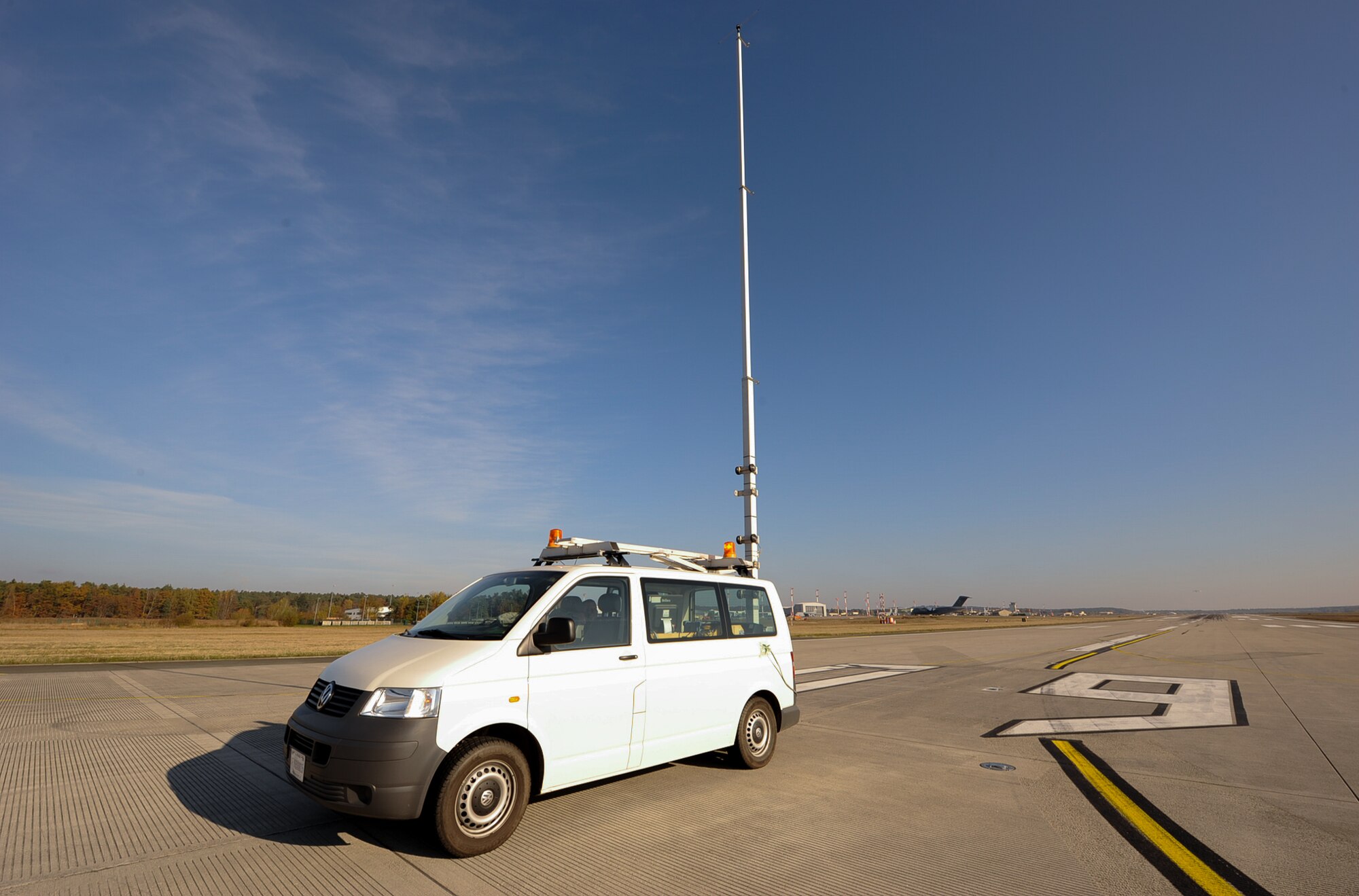 An 86th Operations Support Squadron vehicle sits on the flight line at Ramstein Air Base, Germany, Nov. 14, 2016. The Air Traffic Control and Landing Systems flight uses a specially built test vehicle to drive the length of the runway several times with an antenna 12 meters in height to simulate an aircraft and ensure the signals are being brought directly down the centerline. This system is a zero visibility-auto land system that requires additional checks to verify the system is performing as required. (U.S. Air Force photo by Airman 1st Class Savannah L. Waters)