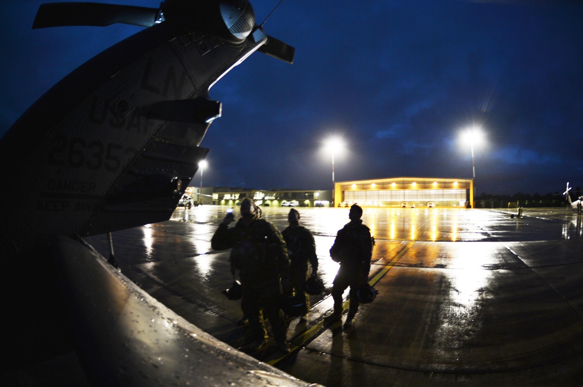 U.S. Air Force pilots from the 56th Rescue Squadron at Royal Air Force Lakenheath, England, inspect a U.S. Air Force HH-60G Pave Hawk helicopter Nov. 10, prior to flying a night training mission during Exercise Salamander at Cazaux Air Base, France. Two Pave Hawks and approximately 100 Airmen from the 56th and 57th RQSs are involved in the joint training exercise with French air force members and helicopters. (U.S. Air Force photo/Master Sgt. Eric Burks)
