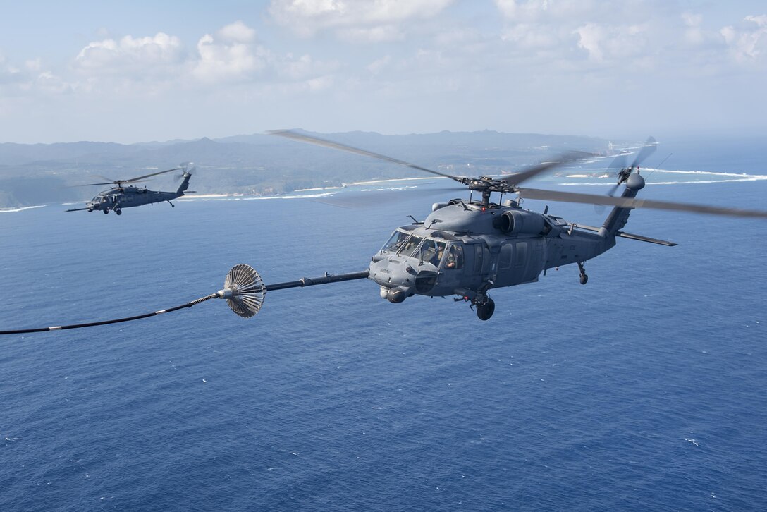 An MC-130H Combat Talon II from the 1st Special Operations Squadron refuels an HH-60 Pave Hawk from the 943rd Rescue Group during exercise Keen Sword 17 on Nov. 7, 2016, near Okinawa, Japan. U.S. forces will conduct training with their Japan Self-Defense Force counterparts at military installations throughout mainland Japan, Okinawa and in the waters surrounding Japan. (U.S. Air Force photo/Airman 1st Class Corey M. Pettis)
