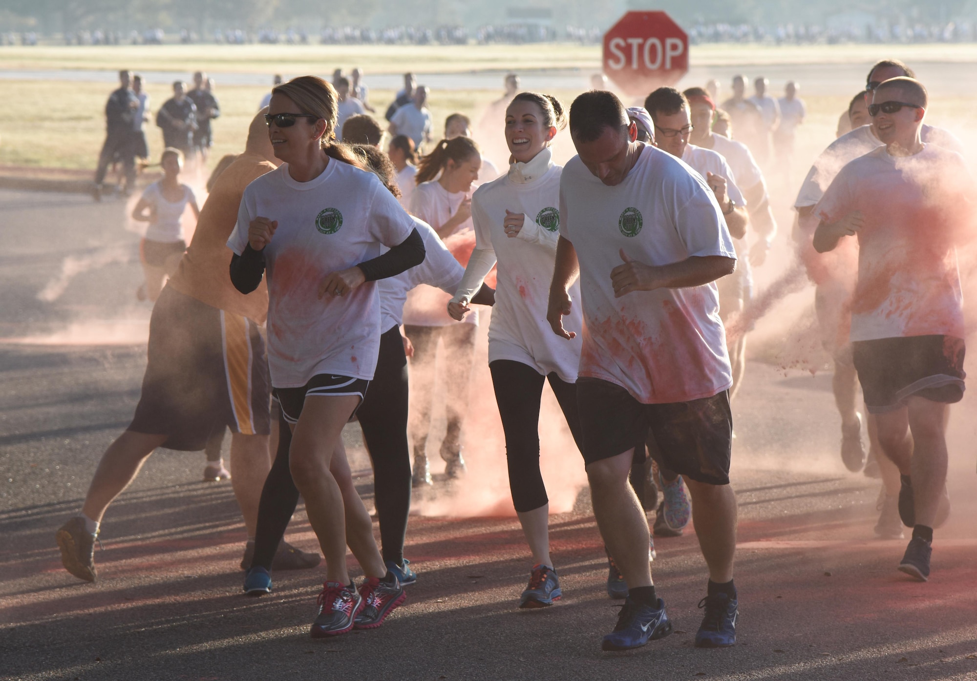 Col. Michele Edmondson, 81st Training Wing commander, and Chief Master Sgt. Anthony Fisher, 81st Training Group superintendent, participate in a Wing color run at the Marina Park Nov. 17, 2016, on Keesler Air Force Base, Miss. The run was one of several events held throughout Dragon Week, which focuses on resiliency and teambuilding initiatives across the base. (U.S. Air Force photo by Kemberly Groue/Released)