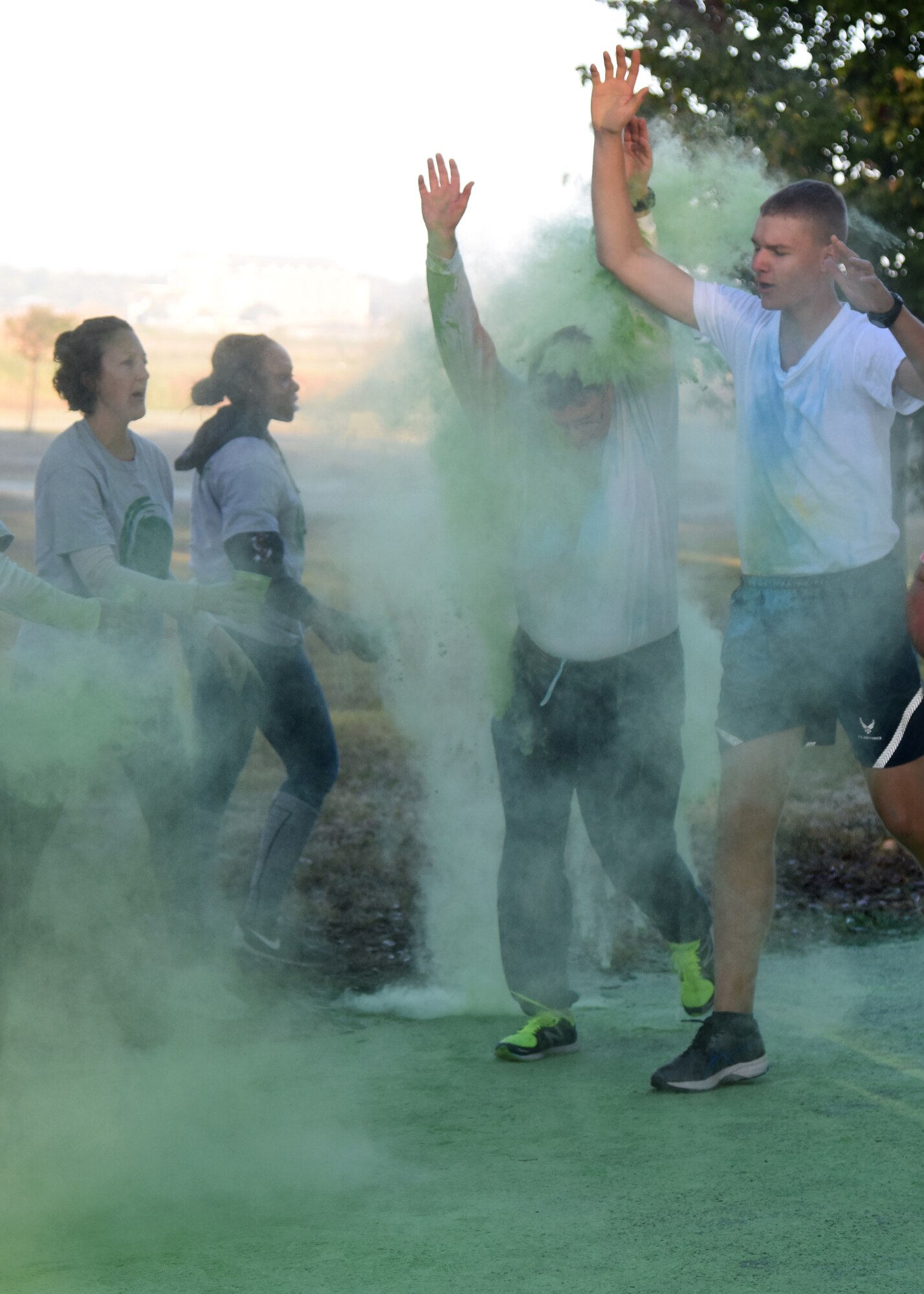 Keesler personnel run through green powder during an 81st Training Wing color run at the Marina Park Nov. 17, 2016, on Keesler Air Force Base, Miss. The run was one of several events held throughout Dragon Week, which focuses on resiliency and teambuilding initiatives across the base. (U.S. Air Force photo by Kemberly Groue/Released)