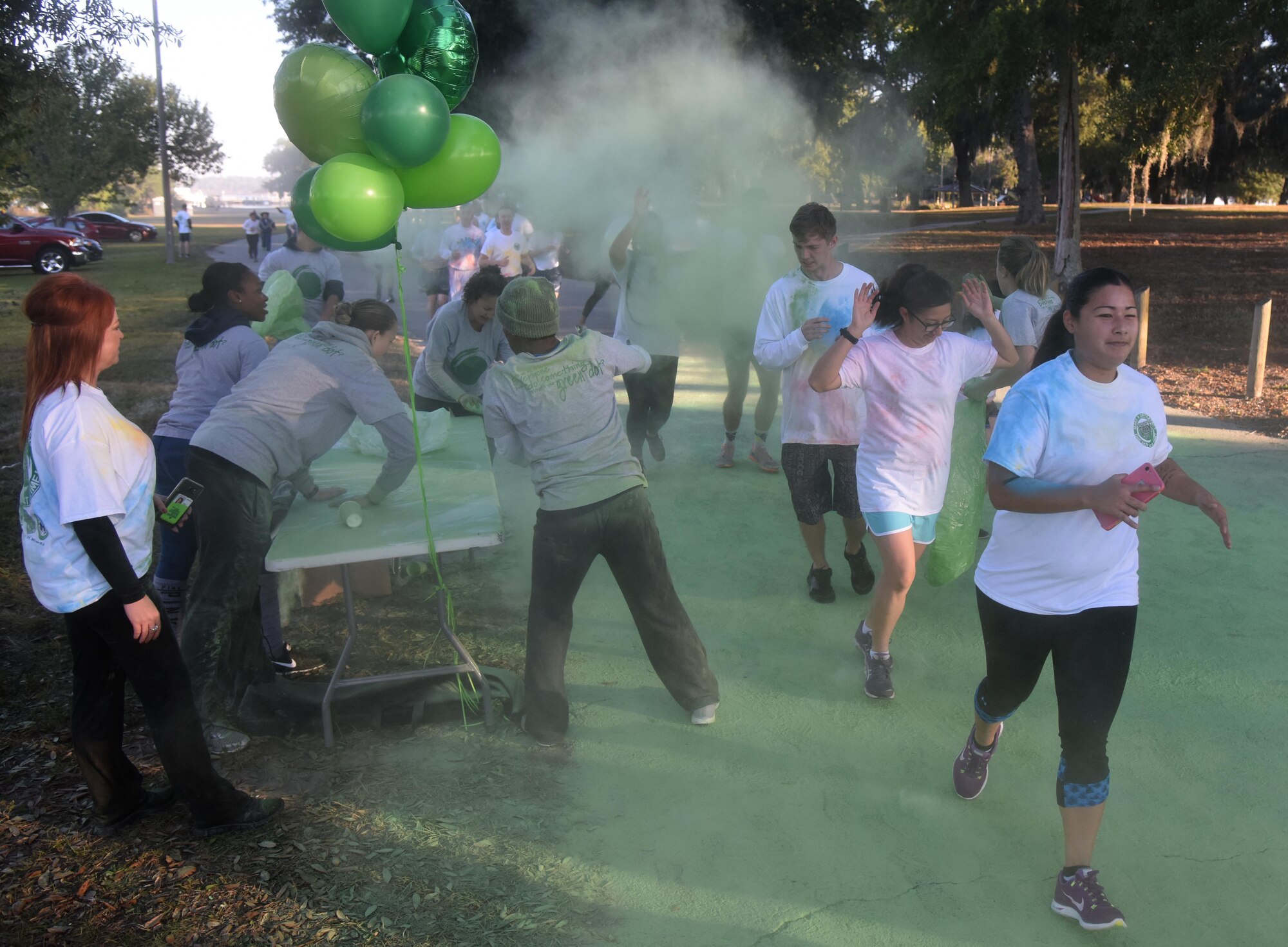 Keesler personnel run through green powder during an 81st Training Wing color run at the Marina Park Nov. 17, 2016, on Keesler Air Force Base, Miss. The run was one of several events held throughout Dragon Week, which focuses on resiliency and teambuilding initiatives across the base. (U.S. Air Force photo by Kemberly Groue/Released)