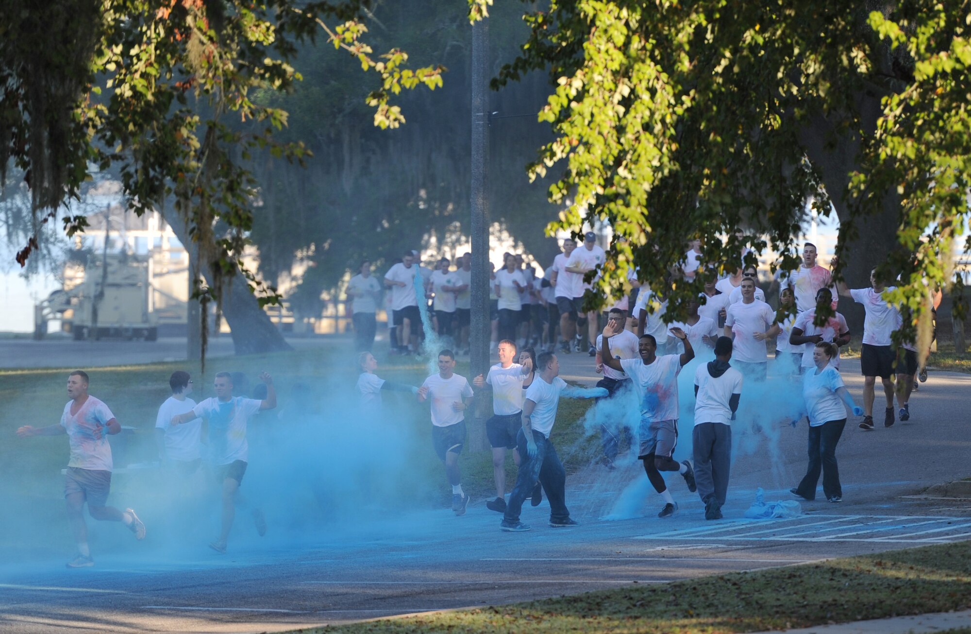 Keesler personnel run through blue powder during an 81st Training Wing color run at the Marina Park Nov. 17, 2016, on Keesler Air Force Base, Miss. The run was one of several events held throughout Dragon Week, which focuses on resiliency and teambuilding initiatives across the base. (U.S. Air Force photo by Kemberly Groue/Released)