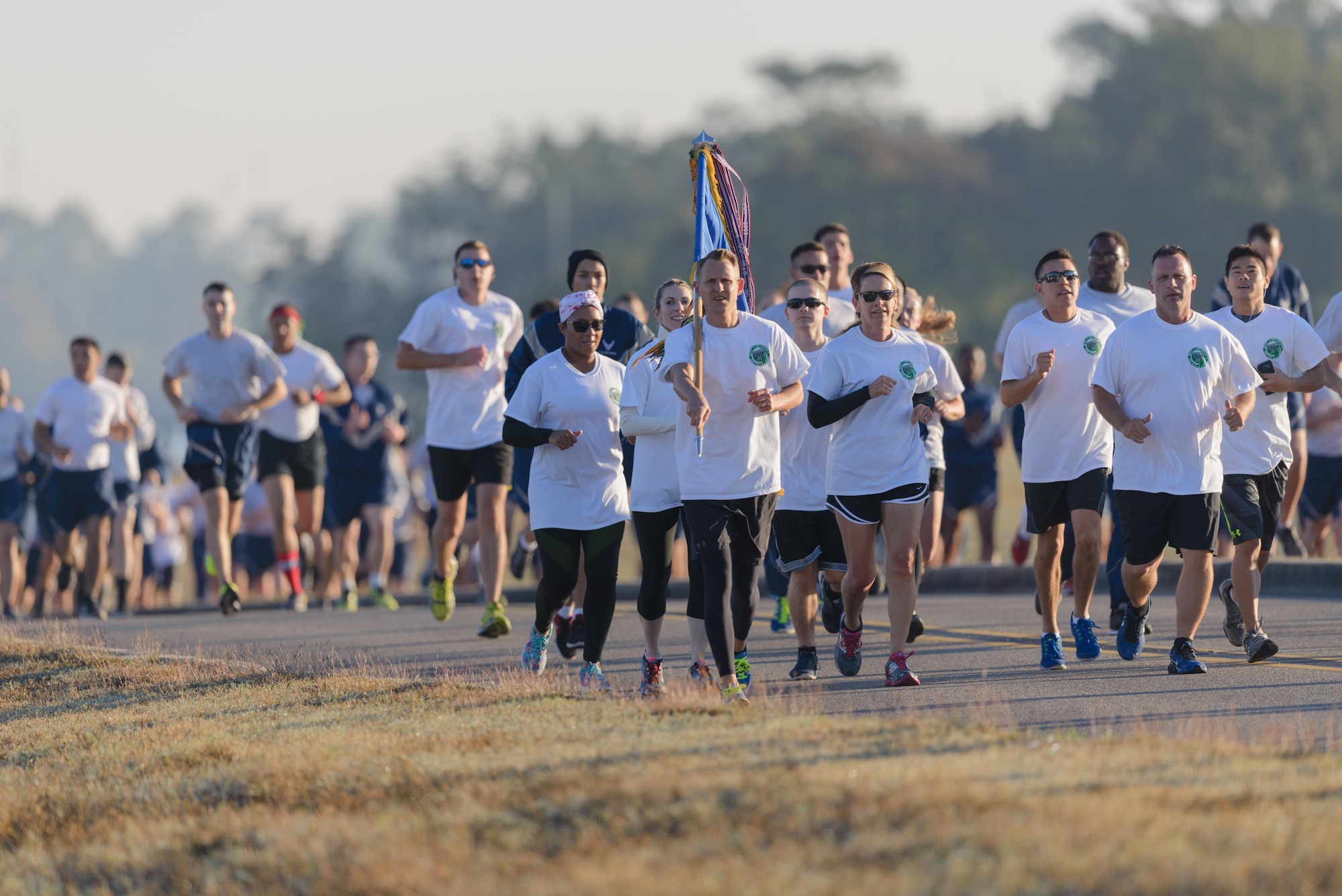 Col. Michele Edmondson, 81st Training Wing commander, and Chief Master Sgt. Anthony Fisher, 81st Training Group superintendent, participate in a Wing color run at the Marina Park Nov. 17, 2016, on Keesler Air Force Base, Miss. The run was one of several events held throughout Dragon Week, which focuses on resiliency and teambuilding initiatives across the base. (U.S. Air Force photo by André Askew/Released)