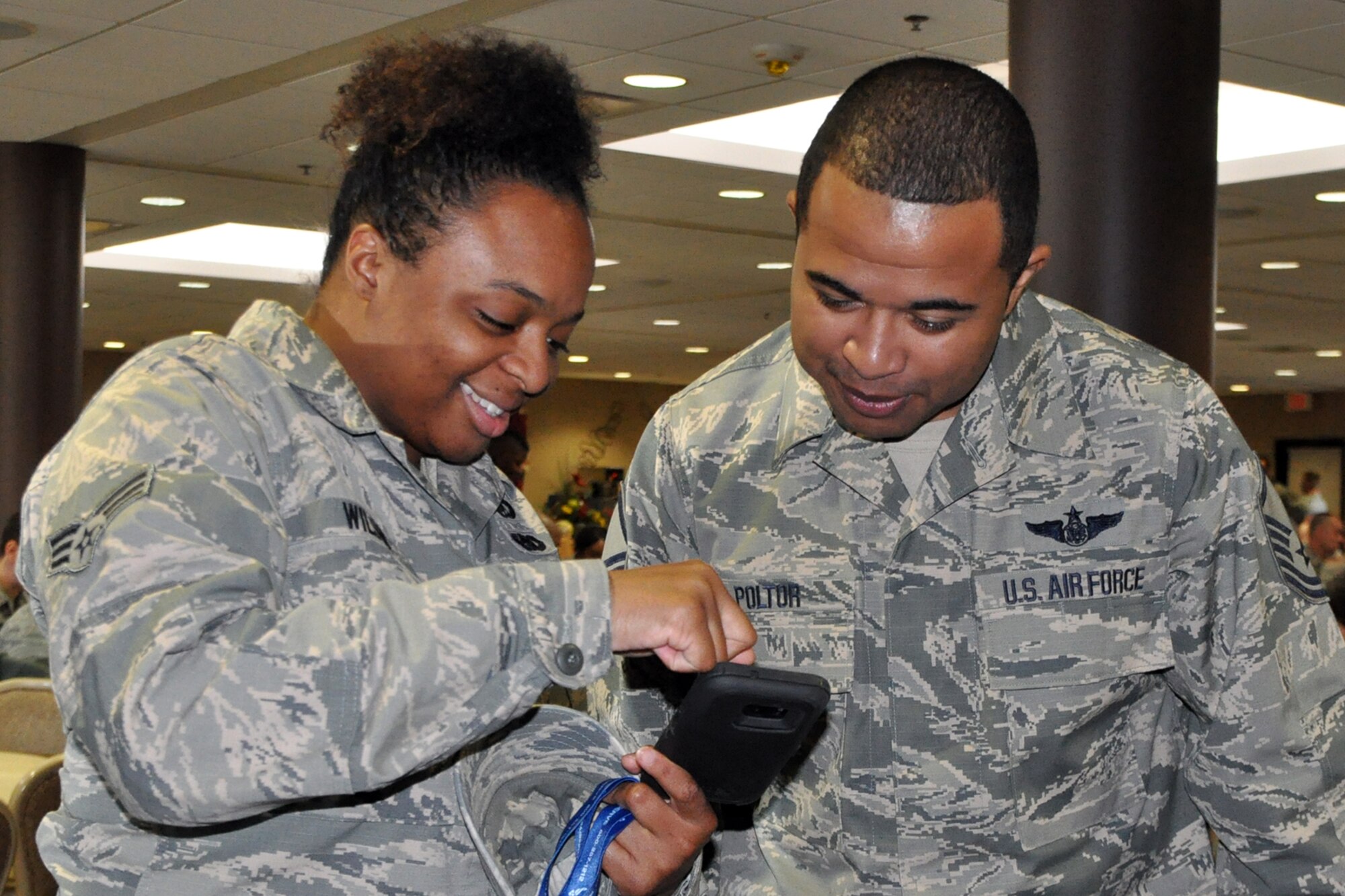 YOUNGSTOWN AIR RESERVE STATION, Ohio -- Air Force Reserve Line Recruiter Master Sgt. Joseph Poltor shows the Get 1 Now smart phone peer recruiting referral application to Senior Airman Thursday Wilson, president of the 910th Airlift Wing Airman’s Council and the 757th Airlift Squadron resource manager, at the Community Activity Center here, Nov. 5, 2016. Encouraging the use of the app which Air Force Reservists and civilian employees can download by visiting their device’s respective app store and searching “Get 1 Now” was among many factors that led to Poltor recently being named the Air Force Reserve’s Top Non-Prior Service Recruiter. (U.S. Air Force photo by Master Sgt. Bob Barko Jr.)         