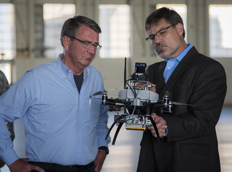 Dr. Rob Murphey, Air Force Research Lab Munitions Directorate, talks with Secretary of Defense Ash Carter about a quadcopter during a visit to Eglin Air Force Base, Fla. Nov. 17.  Carter visited numerous locations around Eglin and Hurlburt Field during his day tour of the local area. (U.S. Air Force photo/Samuel King Jr.)