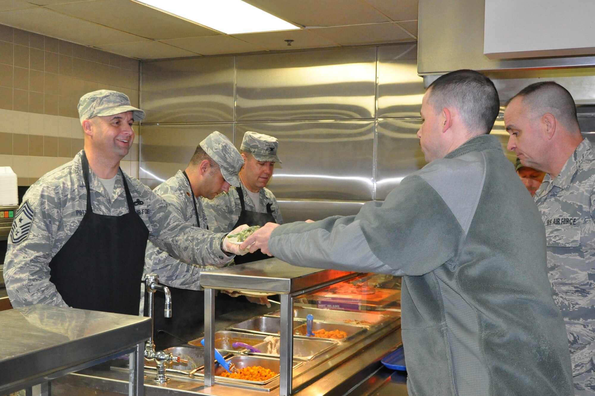 910th Airlift Wing Command Chief Master Sgt. Robert Potts serves a Thanksgiving lunch to a Citizen Airman at the Community Activity Center here, Nov. 5, 2016. Wing leadership serving a Thanksgiving meal to 910th members during the November Unit Training Assembly is a long-standing tradition at YARS. (U.S. Air Force photo/Master Sgt. Bob Barko Jr.)