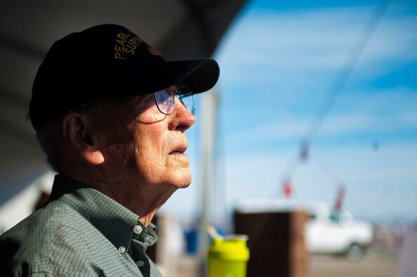 Lenoard Nielson, watches as an aircraft passes by during the Aviation Nation air show at Nellis Air Force Base, Nev., Nov. 12. Nielson is a 94 year old Pearl Harbor survivor. He was a Navy Lt. Junior Grade ship vetter. He was a part of a group of people trained in firefighting, damage control to the ship and making all the repairs possible to keep the ship afloat if it was damaged. (U.S. Air Force photo by Senior Airman Rachel Loftis/released)
