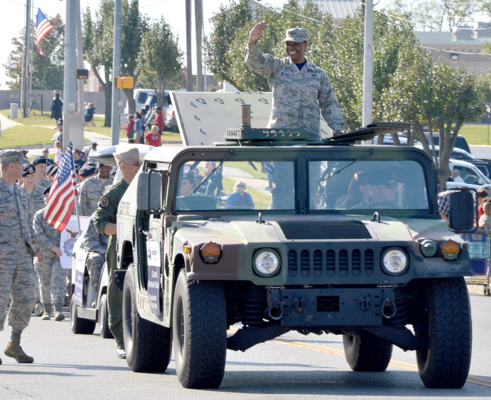 Col. Stephanie Wilson, 72nd Air Base Wing commander, waves to the crowd at the annual Midwest City Veterans Day parade Nov. 11. Walking along with Colonel Wilson’s Humvee were CAPT. Ed McCabe, Strategic Communications Wing ONE and Task Force 124 commander; Col. Michael Green, 72nd Mission Support Group commander; and 72nd ABW Command Chief Master Sgt. David Tuck. (Air Force photo by April McDonald)