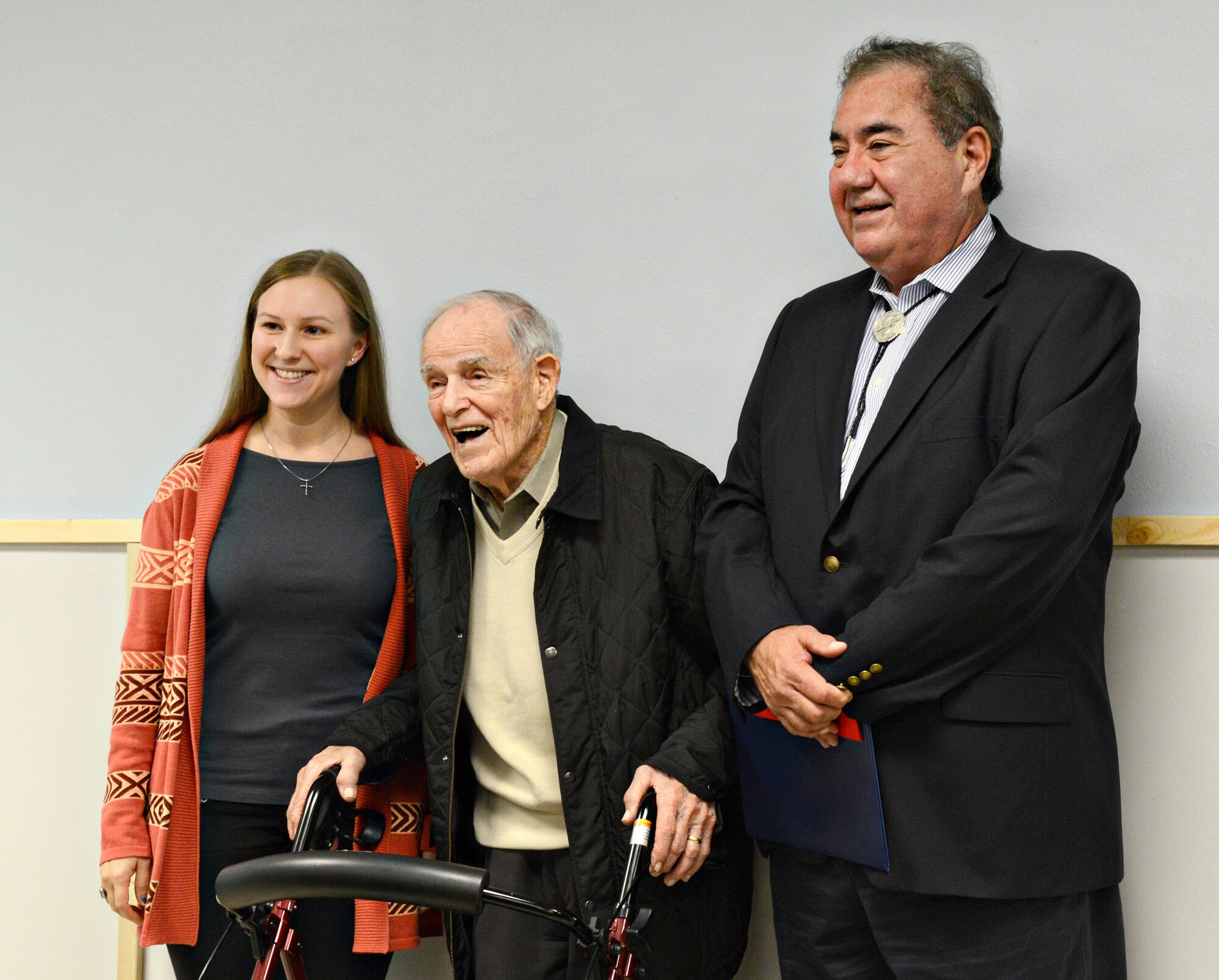 Jenna Smith, great niece of Maj. Gen. Clarence Tinker, left, Bill Tinker, the general’s nephew, and Principal Chief Geoffrey Standing Bear of the Osage Nation pose for pictures during the dedication of the Lecture Hall in Pawhuska High School in honor of General Tinker. The renovation of the lecture hall is being done by the school’s leadership class, led by Maj. Jeffrey Williams, U.S. Army Reserve. (Air Force photo by Kelly White)