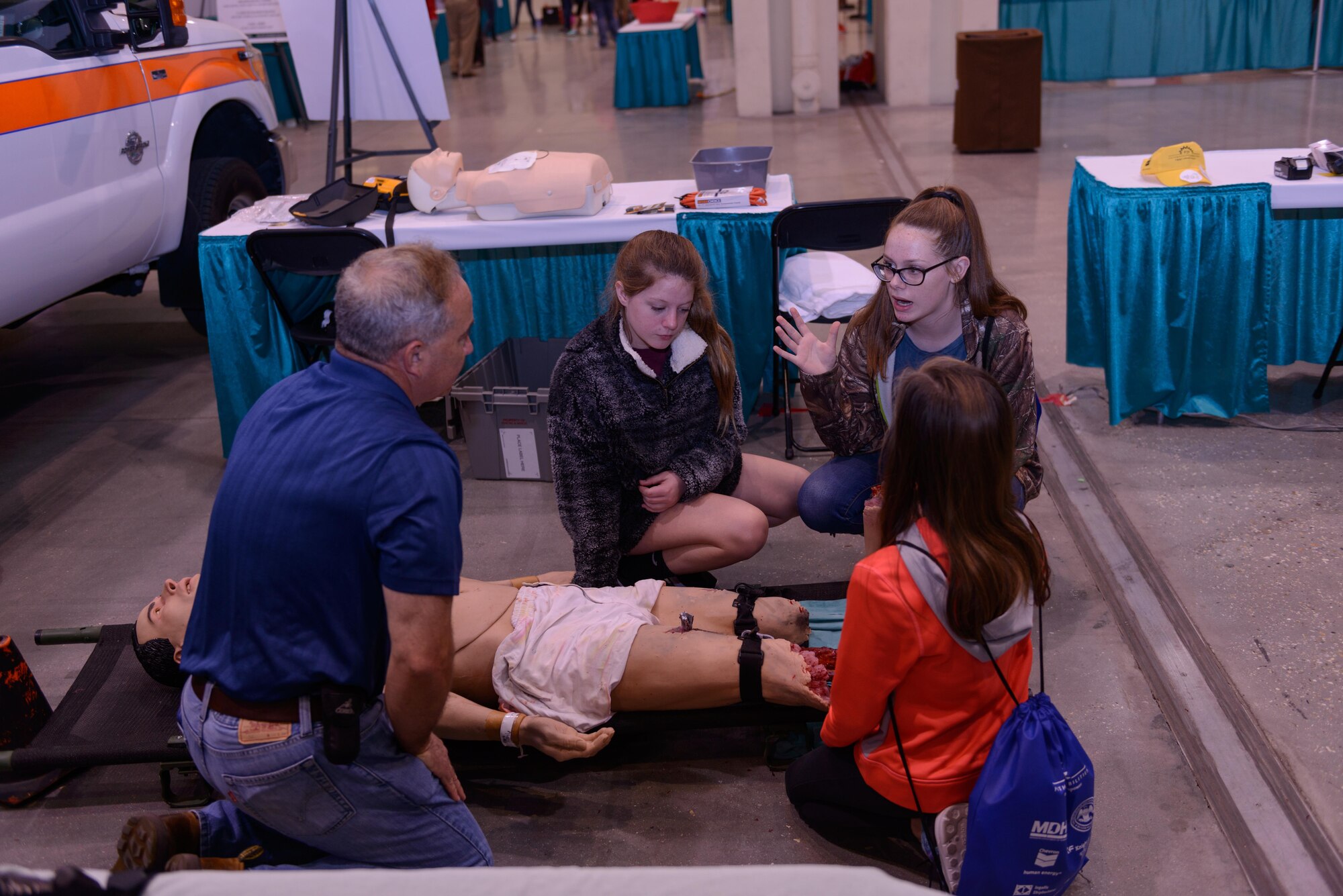 Brad Belford, 81st Medical Group medical simulation operator, Keesler Air Force Base, Miss., answers questions from Long Beach Middle School students during the Pathways2Possibilities (P2P) event at the Mississippi Coast Coliseum & Convention Center Nov. 16, 2016, in Biloxi, Miss.  P2P is a hands-on interactive career expo for all 8th graders and at-risk youth, ages 16-24 in South Mississippi. (U.S. Air Force photo by André Askew/Released)