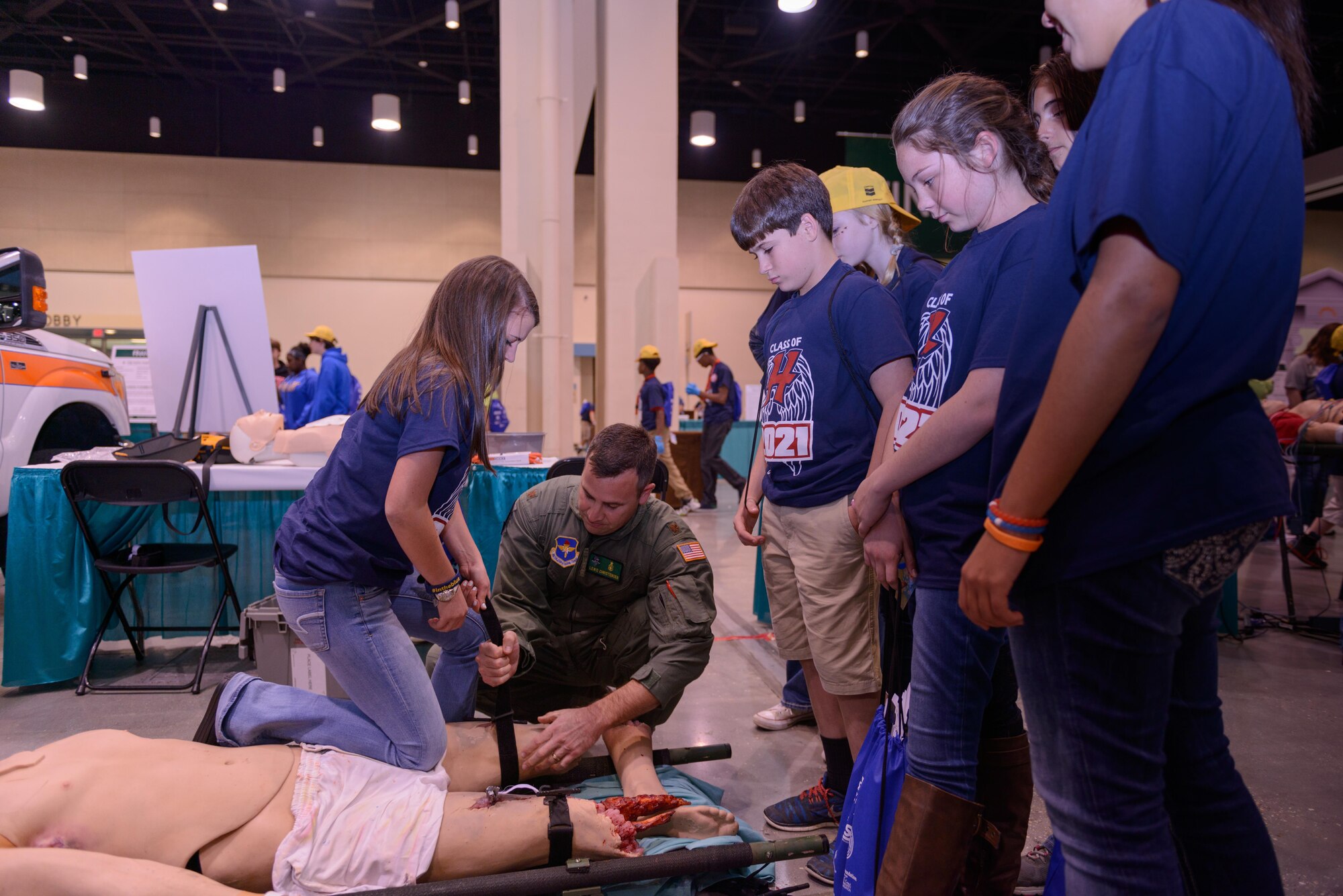 Maj. Lewis Christensen, 81st Medical Operations Squadron emergency room nurse and team tactical critical care evacuation team element leader, Keesler Air Force Base, Miss., supervises Jasmine Alexander, Hancock Middle School student, on proper procedures when applying a tourniquet as fellow students observe during the Pathways2Possibilities (P2P) at the Mississippi Coast Coliseum & Convention Center Nov. 16, 2016, in Biloxi, Miss.  P2P is a hands-on interactive career expo for all 8th graders and at-risk youth, ages 16-24 in South Mississippi. (U.S. Air Force photo by André Askew/Released)