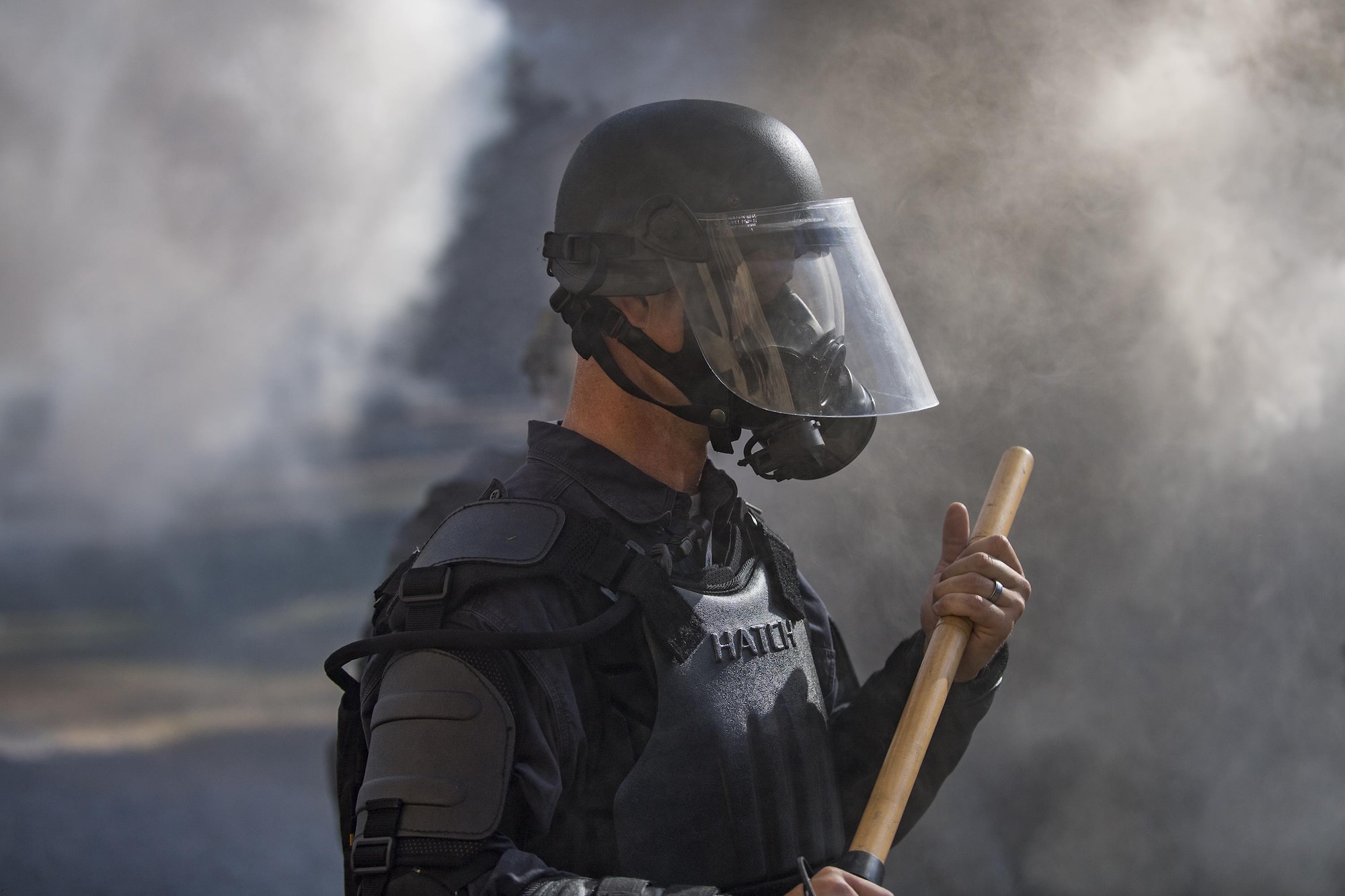 A member of Georgia State Patrol’s Mobile Field Force stands in the haze of smoke grenades, Nov. 16, 2016, at Moody Air Force Base, Ga. Moody facilitated this training by providing the Military Operations in Urban Terrain village, a training area consisting of buildings, obstacles and gravel roads. (U.S. Air Force photo by Airman 1st Class Daniel Snider)