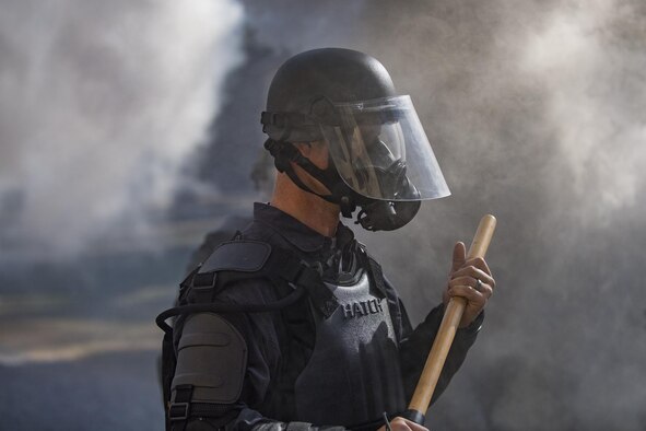 A member of Georgia State Patrol’s Mobile Field Force stands in the haze of smoke grenades Nov. 16, 2016, at Moody Air Force Base, Ga., during riot training. Moody facilitated this training by providing the Military Operations in Urban Terrain village, a training area consisting of buildings, obstacles and gravel roads. (U.S. Air Force photo/Airman 1st Class Daniel Snider)