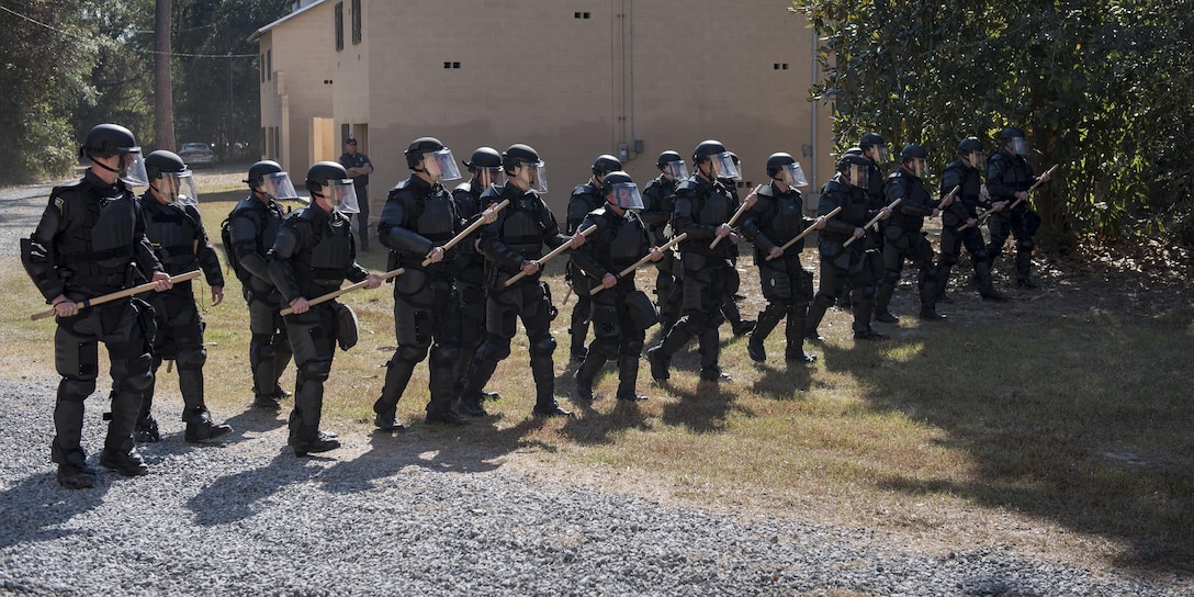 Georgia State Patrol’s Mobile Field Force create a wall of police officers as they march forward, Nov. 16, 2016, at Moody Air Force Base, Ga. The GSP conducts semiannual riot control training to ensure readiness if a situation arises. (U.S. Air Force photo by Airman 1st Class Daniel Snider)