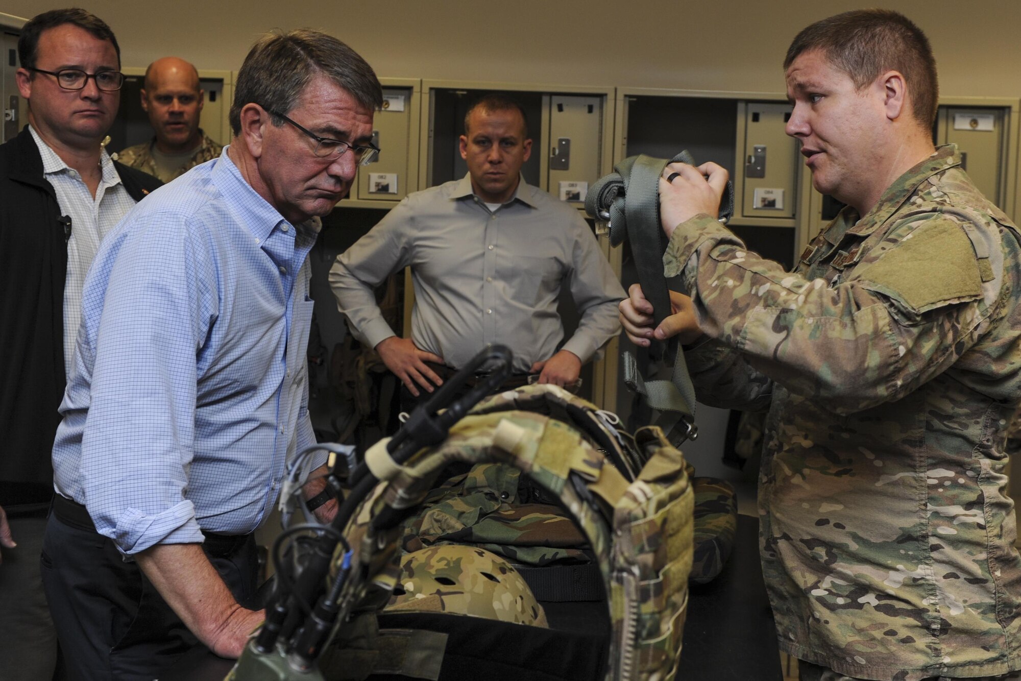 Secretary of Defense Ash Carter receives flight equipment and a brief from Senior Airman Adam Milton, aircrew flight equipment specialist with the 8th Special Operations Squadron, before his flight on a CV-22 Osprey during a visit to Hurlburt Field, Fla., Nov. 17, 2016. During his flight, Carter experienced a tiltrotor air-to-air refueling with an MC-130H Combat Talon II assigned to the 15th SOS. During his time at Hurlburt Field, he also visited with Air Force Special Operations Command Air Commandos and participated in a Joint Assault Force with Special Tactics teams. (U.S. Air Force photo by Staff Sgt. Kentavist Brackin)
