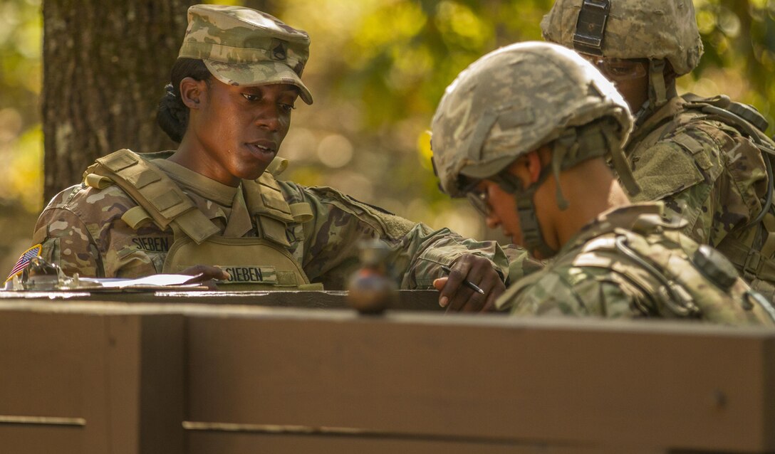 Army Drill Sergeant, Staff Sgt. Akia Sieben assist Pvt. Diego Garcia, an Army Reserve Soldier, both with basic combat training Company A, 1st Battalion, 61st Infantry Regiment at Fort Jackson, S.C., during the hand grenade assault course, Oct. 19. (U.S. Army Reserve photo by Sgt. Stephanie Hargett/ released)