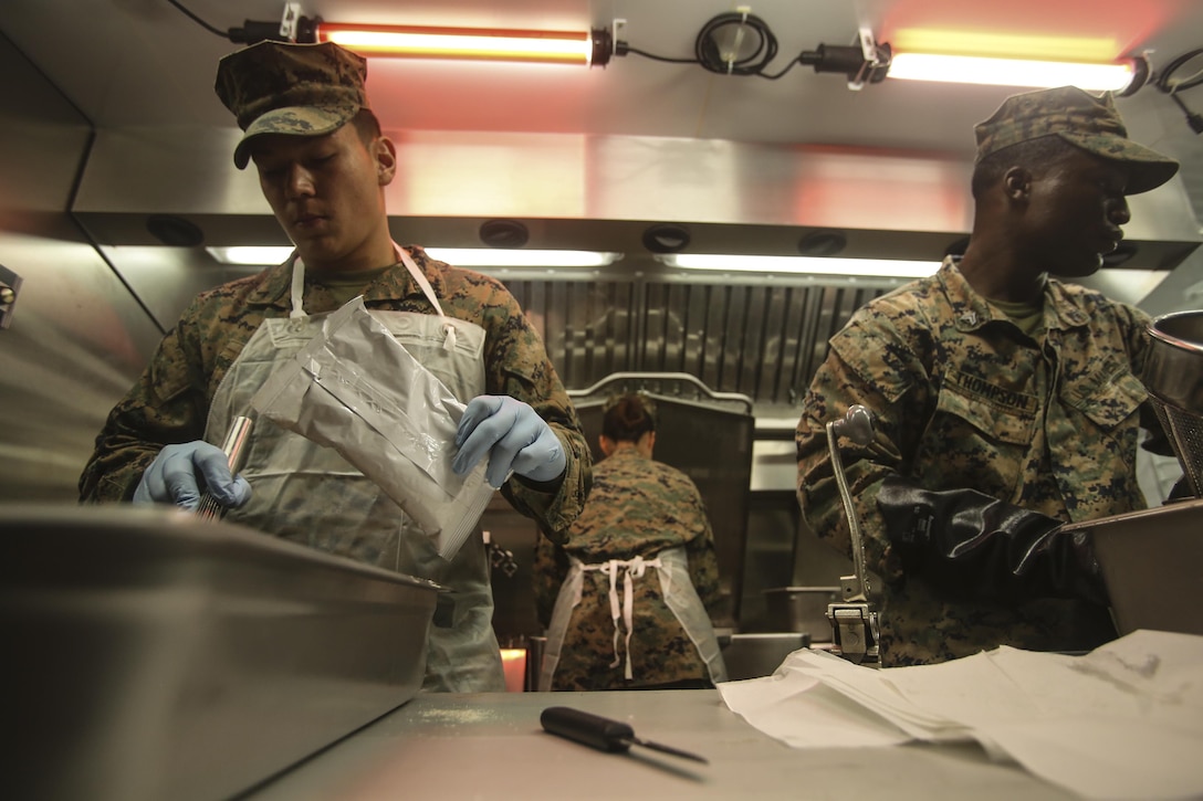 Marines prepare food to feed the Marines and sailors participating in the 2nd Marine Logistics Group squad competition at Camp Lejeune, N.C., Nov. 17, 2016. The Marines are graded and judged as part of the W.P.T. Hill inspection, a challenge to see which food service unit can be the most successful at creating a field mess hall. The Marines are with Food Service Company, Headquarters Regiment, 2nd MLG. (U.S. Marine Corps photos by Lance Cpl. Miranda Faughn)
