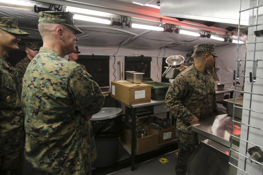 Brigadier Gen. David Maxwell visits his Marines and wishes them luck while they cook for the Marines of the 2nd Marine Logistics Group squad competition at Camp Lejeune, N.C., Nov. 17, 2016. Cooking for the Marines of the squad competition is the first round of the W.P.T. Hill competition where the Marines prepared food and were judged on their cleanliness, recipe compliance, teamwork, quality of food and execution. The Marines are with Food Service Company, Headquarters Regiment, 2nd MLG; Maxwell is the commanding general for 2nd MLG. (U.S. Marine Corps photos by Lance Cpl. Miranda Faughn)