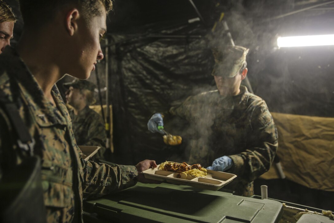 Marines prepare and serve food to the Marines and sailors participating in the 2nd Marine Logistics Group squad competition at Camp Lejeune, N.C., Nov. 17, 2016. The Marines serving were graded and judged as part of the W.P.T. Hill inspection, a challenge to see which food service unit can be most successful at creating a field mess hall. They were inspected on their cleanliness, recipe compliance, teamwork, quality of food and execution.  The Marines are with Food Service Company, Headquarters Regiment, and other 2nd MLG units. (U.S. Marine Corps photos by Lance Cpl. Miranda Faughn)