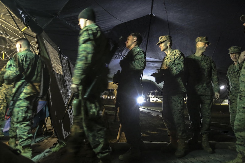 Marines and Sailors wait to be served their “Warriors Meal” after participating in the 2nd Marine Logistics Group squad competition at Camp Lejeune, N.C., Nov. 17, 2016. While the participants enjoy their meal, their servers were evaluated in their own competition on cleanliness, recipe compliance, teamwork, quality of food and execution for the W.P.T. Hill award. The Marines presenting the food are with Food Service Company, Headquarters Regiment, 2nd MLG. (U.S. Marine Corps photos by Lance Cpl. Miranda Faughn)