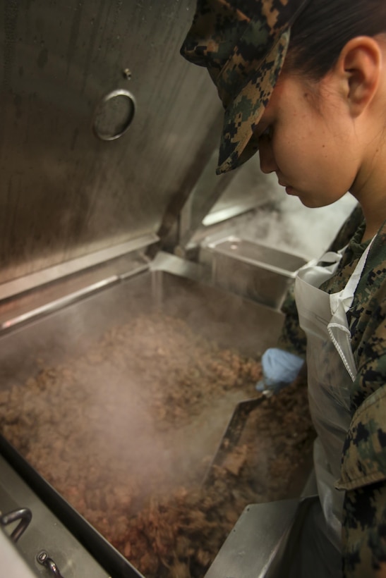 PFC. Claudia Padilla prepares meat to serve to Marines and sailors participating in the 2nd Marine Logistics Group squad competition at Camp Lejeune, N.C., Nov. 17, 2016.  While the other Marines take part in their competition, the food service Marines were critiqued on their ability to run an efficient and sanitary field mess hall for the annual W.P.T. Hill competition. Padilla is with Food Service Company, Headquarters Regiment, 2nd MLG. (U.S. Marine Corps photos by Lance Cpl. Miranda Faughn)