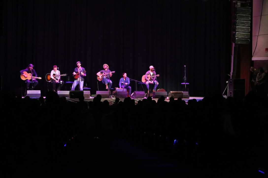 Audience members listen to a performance by country singers during the 8th annual Guitar Pull at Marine Corps Air Station Cherry Point, N.C. Nov. 16, 2016. More than 1,800 Marines, Sailors and members of the community came together to enjoy a free concert with musical artists like Trace Adkins, Jerrod Niemann, Josh Turner and more. The event brought forth an opportunity for service members and locals to interact with each other in a unique environment. (U.S. Marine Corps photo by Sgt. N.W. Huertas/ Released)