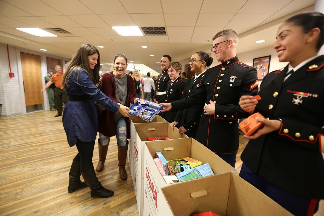 Members of the community donate toys at the 8th annual Guitar Pull at Marine Corps Air Station Cherry Point, N.C. Nov. 16, 2016. More than 1,800 Marines, Sailors and members of the community came together to enjoy a free concert with musical artists like Trace Adkins, Jerrod Niemann, Josh Turner and more. The event brought forth an opportunity for service members and locals to interact with each other in a unique environment. (U.S. Marine Corps photo by Sgt. N.W. Huertas/ Released)