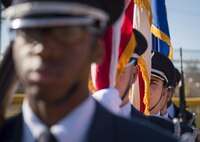 Honor Guard member, Senior Airman Burak Raymond, holds the Floridian flag while waiting for the presentation of the colors at a ceremony Nov. 16, at Eglin Air Force Base, Fla. In 2016, the base's honor guard teams traveled 190,823 miles to complete 458 details between 20 counties and two states.  (U.S. Air Force photo/Samuel King Jr.)