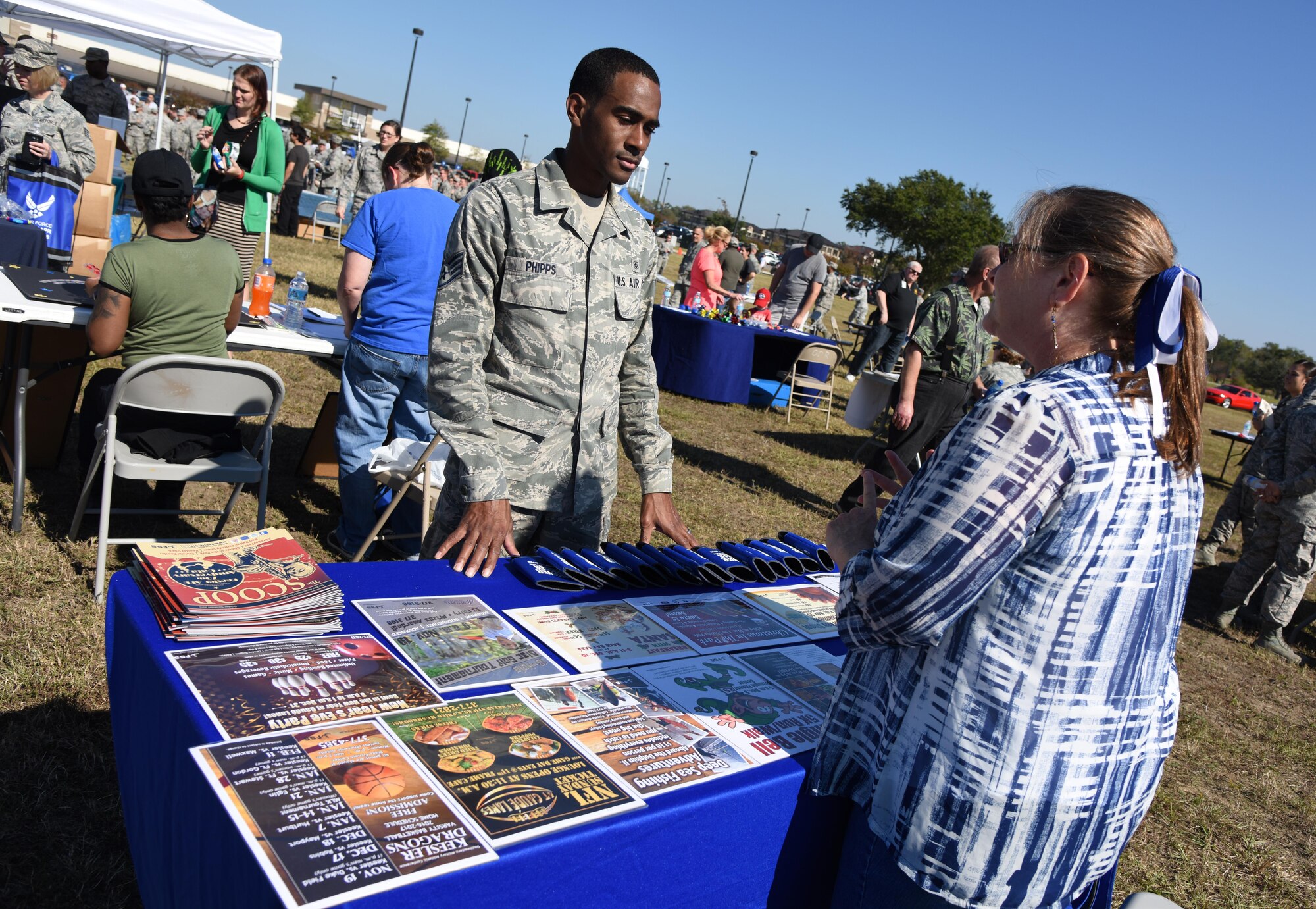 Cindy Milford, 81st Force Support Squadron publicist, provides information about Keesler events to Staff Sgt. Michael Phipps, 81st Dental Squadron oral surgery technician, during Dragon Fest Nov. 17, 2016, on Keesler Air Force Base, Miss. Dragon Fest was the final event held for Dragon Week, which focused on resiliency and teambuilding initiatives across the base. (U.S. Air Force photo by Kemberly Groue)