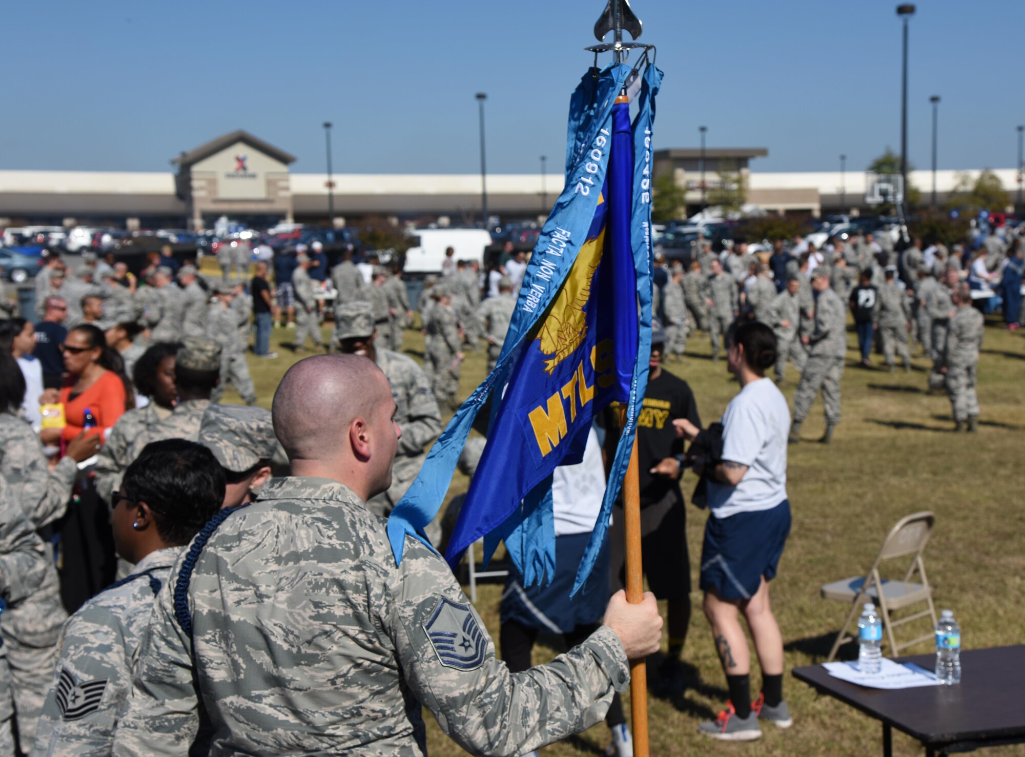 Master Sgt. Kyle Mullen, 81st Training Support Squadron military training leader instructor, holds his unit’s guidon during Dragon Fest Nov. 17, 2016, on Keesler Air Force Base, Miss. Dragon Fest was the final event held for Dragon Week, which focused on resiliency and teambuilding initiatives across the base. (U.S. Air Force photo by Kemberly Groue)