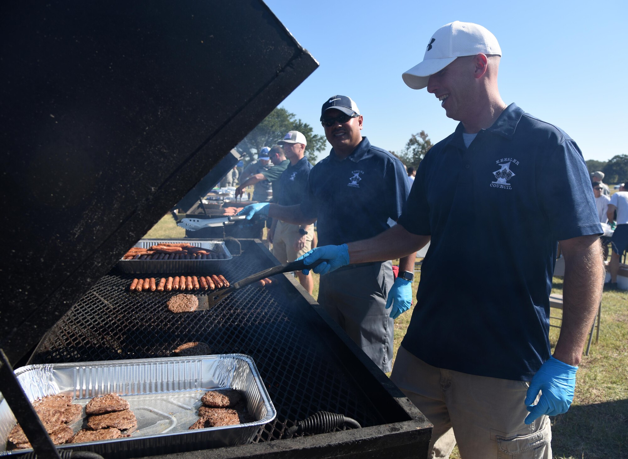 Senior Master Sgt. Noel Ramirez, 81st Contracting Squadron first sergeant, and Master Sgt. Steve Brenneman, 81st Dental Squadron first sergeant, grill burgers and hot dogs during Dragon Fest Nov. 17, 2016, on Keesler Air Force Base, Miss. Dragon Fest was the final event held for Dragon Week, which focused on resiliency and teambuilding initiatives across the base. (U.S. Air Force photo by Kemberly Groue)