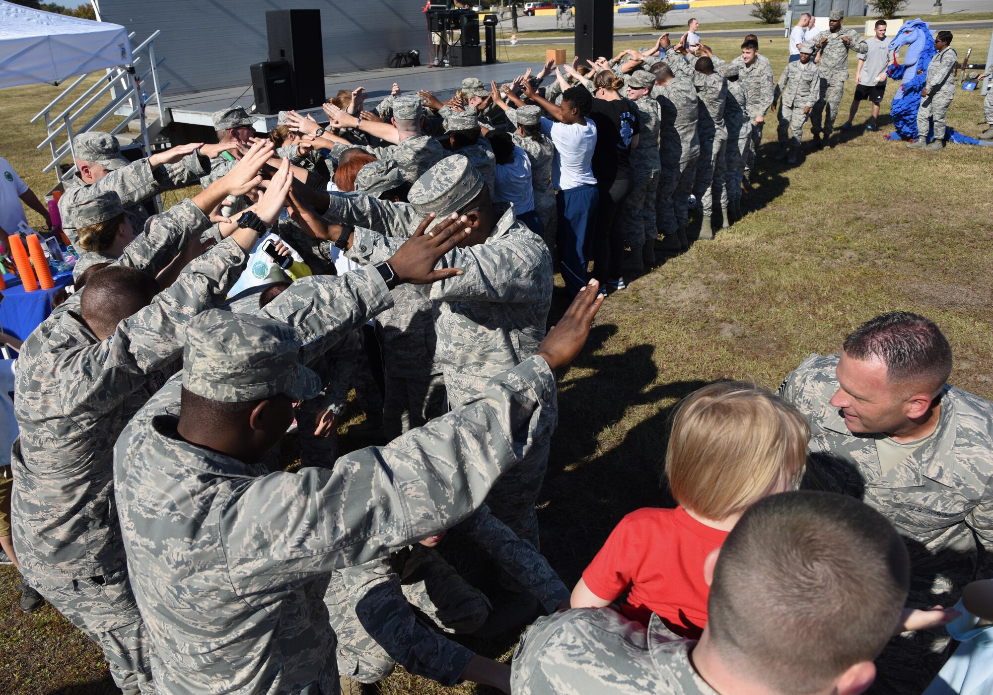 Keesler personnel participate in a conga line during Dragon Fest Nov. 17, 2016, on Keesler Air Force Base, Miss. Dragon Fest was the final event held for Dragon Week, which focused on resiliency and teambuilding initiatives across the base. (U.S. Air Force photo by Kemberly Groue)