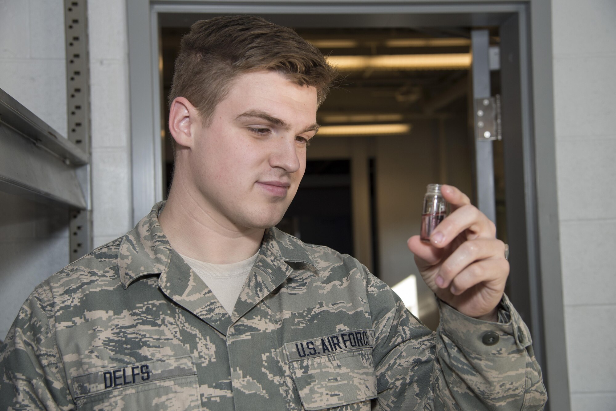 Senior Airman Alexander Delfs, 436th Aerospace Medical Squadron bioenvironmental engineering journeyman, visually inspects a water test sample Nov. 16, 2016, at an aircraft watering point on Dover Air Force Base, Del. Airmen assigned to the 436th AMDS biomedical engineering flight routinely test water pH and chlorine concentration at location. (U.S. Air Force photo by Senior Airman Aaron J. Jenne)