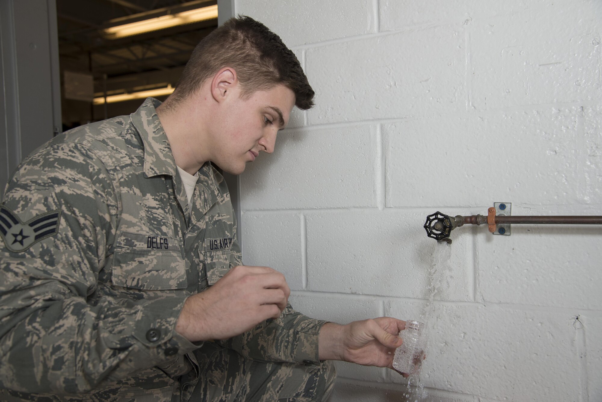Senior Airman Alexander Delfs, 436th Aerospace Medical Squadron bioenvironmental engineering journeyman, collects a water sample for bacteriologic testing Nov. 16, 2016, at an aircraft watering point on Dover Air Force Base, Del. Members of the 436th AMDS bioenvironmental engineering flight send water samples to a laboratory to test for the presence of harmful bacteria in drinking water. (U.S. Air Force photo by Senior Airman Aaron J. Jenne)
