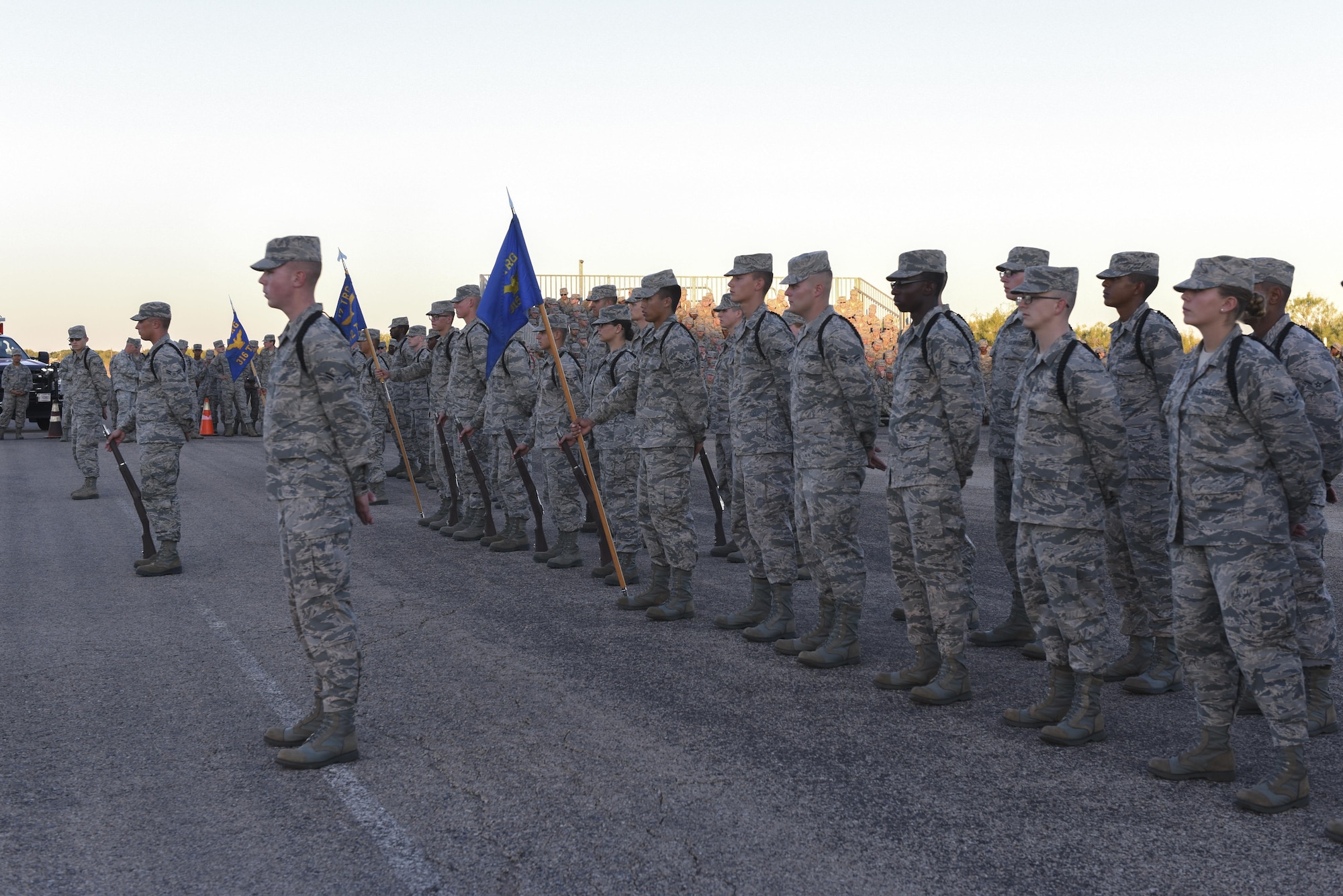 The 312th Training Squadron, 315th Training Squadron and 316th Training Squadron Airmen stand to hear the winners of the 17th Training Group Drill Competition at the flight line on Goodfellow Air Force Base, Texas, Nov. 16, 2016. The 17th TRG held the competition to find the best drill team. (U.S. Air Force photo by Airman 1st Class Chase Sousa/Released)