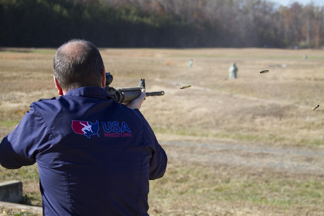 Rich Bender, executive director, USA Wrestling, fires rounds down range during a tour of Marine Corps Base Quantico on Nov. 18, 2016. Bender and other USA Wrestling representatives, including three-time world champion Adeline Gray, took a tour of MCBQ that included a V-22 Osprey flight, a martial arts demonstration, and a shooting range. Through this relationship with USAW, the Marine Corps will also partner with other organizations within the wrestling-related community to further communicate the message of shared values and establish a strong connection with America’s youth 