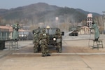 Republic of Korea and US Soldiers work together at the initial wash phase of the vehicle decontamination line to decontaminate a military vehicle during Combined Decontamination Exercise, Nov. 17, 2016. 