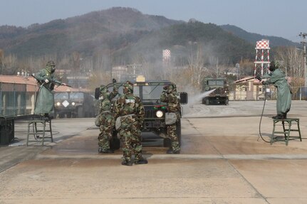 Republic of Korea and US Soldiers work together at the initial wash phase of the vehicle decontamination line to decontaminate a military vehicle during Combined Decontamination Exercise, Nov. 17, 2016. 