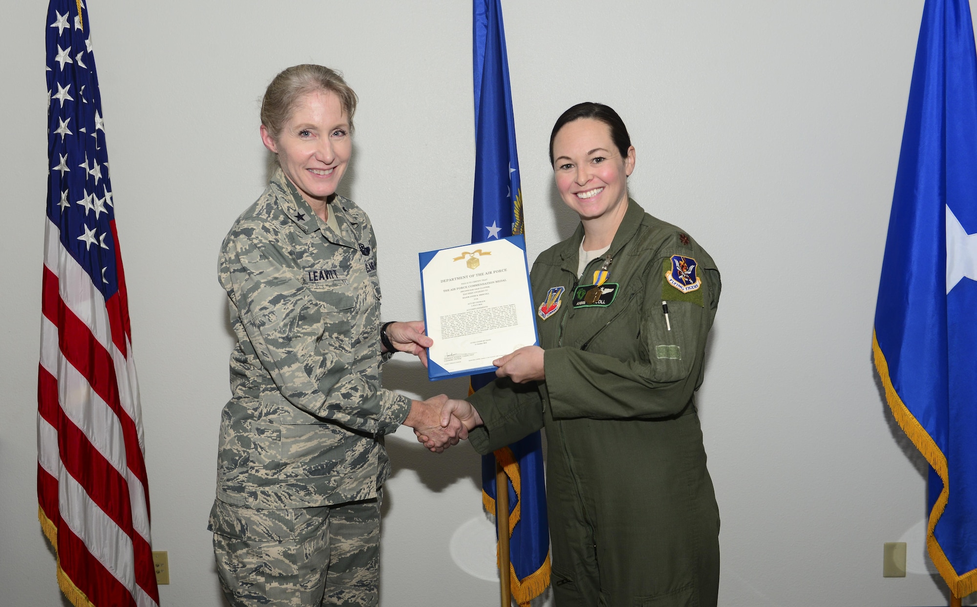 Brig. Gen. Jeannie Leavitt, 57th Wing commander, presents Maj. Annie Driscoll, 66th Rescue Squadron director of staff, the Air Force Commendation Medal, Nov. 17, 2016. Driscoll and her husband, Maj. Maxwell Harrell, 53rd Wing advance program operating location alpha director, saved a man from drowning while they were vacationing in Yosemite National Park during Fourth of July Weekend. (Courtesy photo)